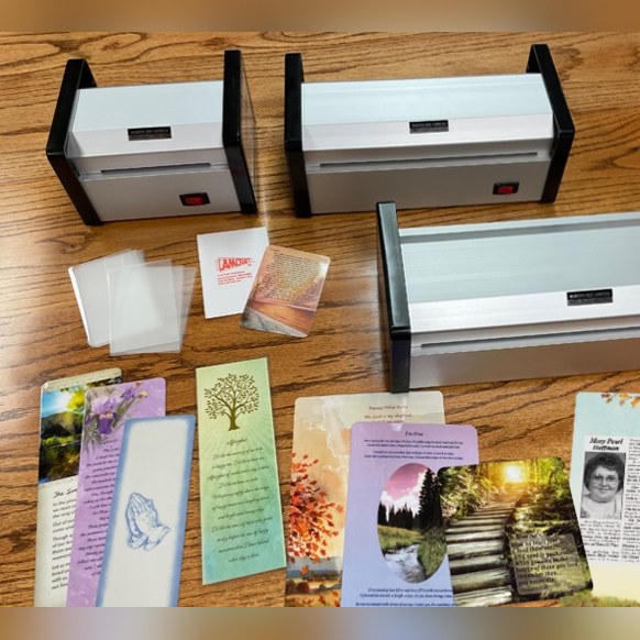 Three Lamcraft pouch laminators with pouches and finished cards